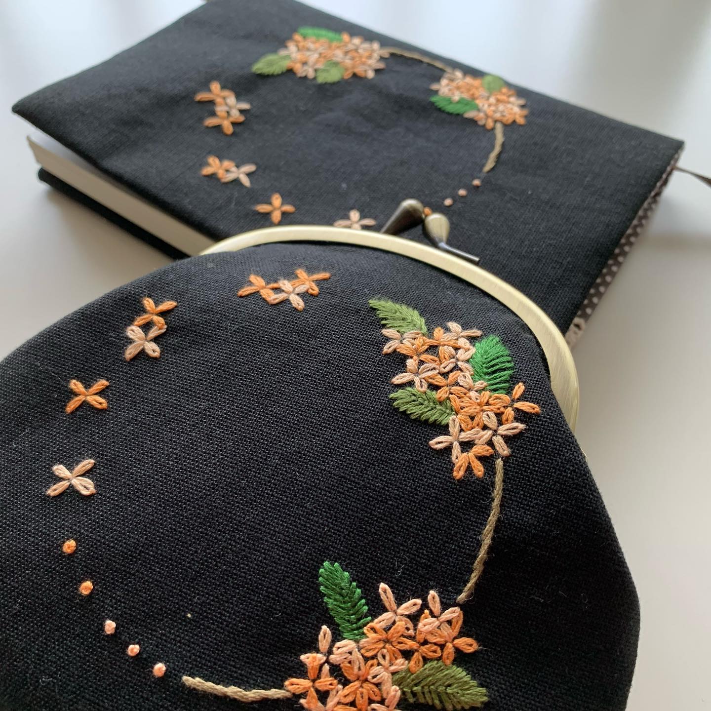 昨日の#キンモクセイ 刺繍のブックカバーとお揃いで、#がま口ポーチ も完成しました。ブックカバーは販売スタートしております。がま口ポーチは明日販売スタートします。暫しお待ちを。#読書の秋 #食欲の秋#おうち時間 が少しでも楽しくなりますように。#minne にて近日販売予定#花のあるくらし#金木犀#kinmokusei #osmanthus #fragmentolive #桂花#丹桂#金桂#金木犀刺繍#金木犀刺繍のブックカバー#文庫本サイズ#花刺繍 #刺繍 #embroidery #手刺繍#handembroidery #handmade #手仕事#手作り#針仕事#needlework#tomoprix